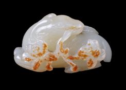 A Chinese white and russet jade ‘ram’ carving
