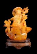 A finely carved amber ‘guanyin and acolyte’ figure