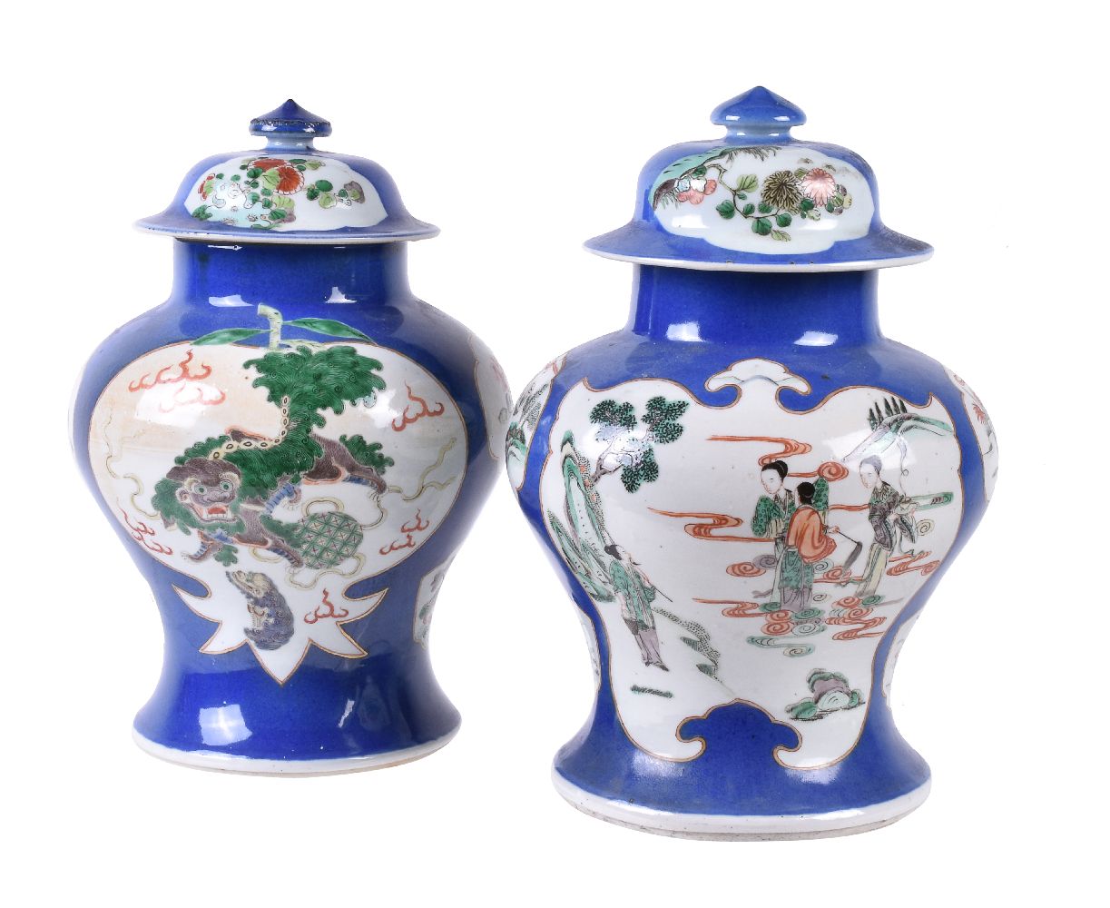 Two Chinese 'Famille Verte' powder-blue ground vases and covers