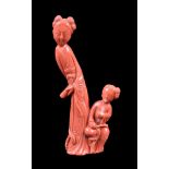 ϒ A Chinese coral figure of a lady and attendant