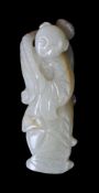 A Chinese celadon and russet jade carving of a boy