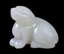 A white or pale celadon jade carving of a dog