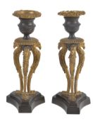 A pair of Regency parcel gilt and patinated bronze candlesticks