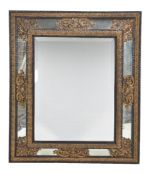 ϒ A Continental ebony and giltmetal mounted marginal wall mirror