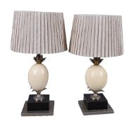 A pair of silvered metal table lamps mounted with ostrich eggs by Redmile London