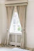 A pair of full length curtains in green and cream stripe