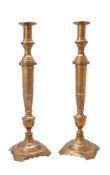 A pair of oversized brass candlesticks