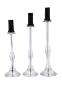 A set of three graduated Murano purple and clear glass candlesticks