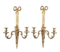 A set of four gilt metal three light wall appliques in Louis XVI style