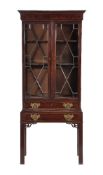 A mahogany display cabinet on stand