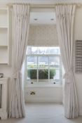 A pair of full length curtains in beige linen mix material