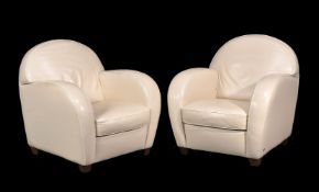 A pair of cream leather upholstered ‘club’ armchairs