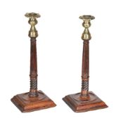 A pair of George III brass mounted turned and carved mahogany columnar candlesticks