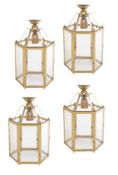 A set of four gilt metal and glazed hexagonal hall lanterns