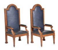 A pair of oak and leather upholstered armchairs