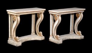 A pair of white painted and parcel gilt console tables in Regency style
