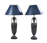 A pair of French patinated metal oil lamp bases in Neoclassical taste