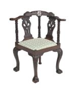 ϒ A carved mahogany corner armchair