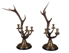 A pair of antler mounted five light brass candelabra by Redmile London