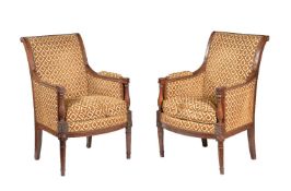 A pair of French walnut and upholstered armchairs