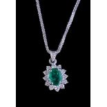 An emerald and diamond cluster pendant