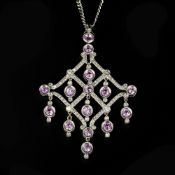 A pink sapphire and diamond pendant