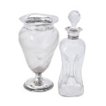 An Edwardian silver collared clear glass glug-glug decanter by J. C. Plimpton & Co.