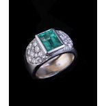 An emerald and diamond ring