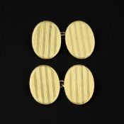 A pair of gold coloured double sided cufflinks