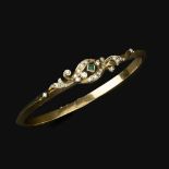 An emerald and diamond bangle