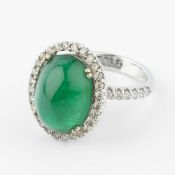 An emerald and diamond cluster ring