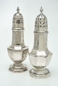 Two similar silver octagonal vase shaped sugar casters