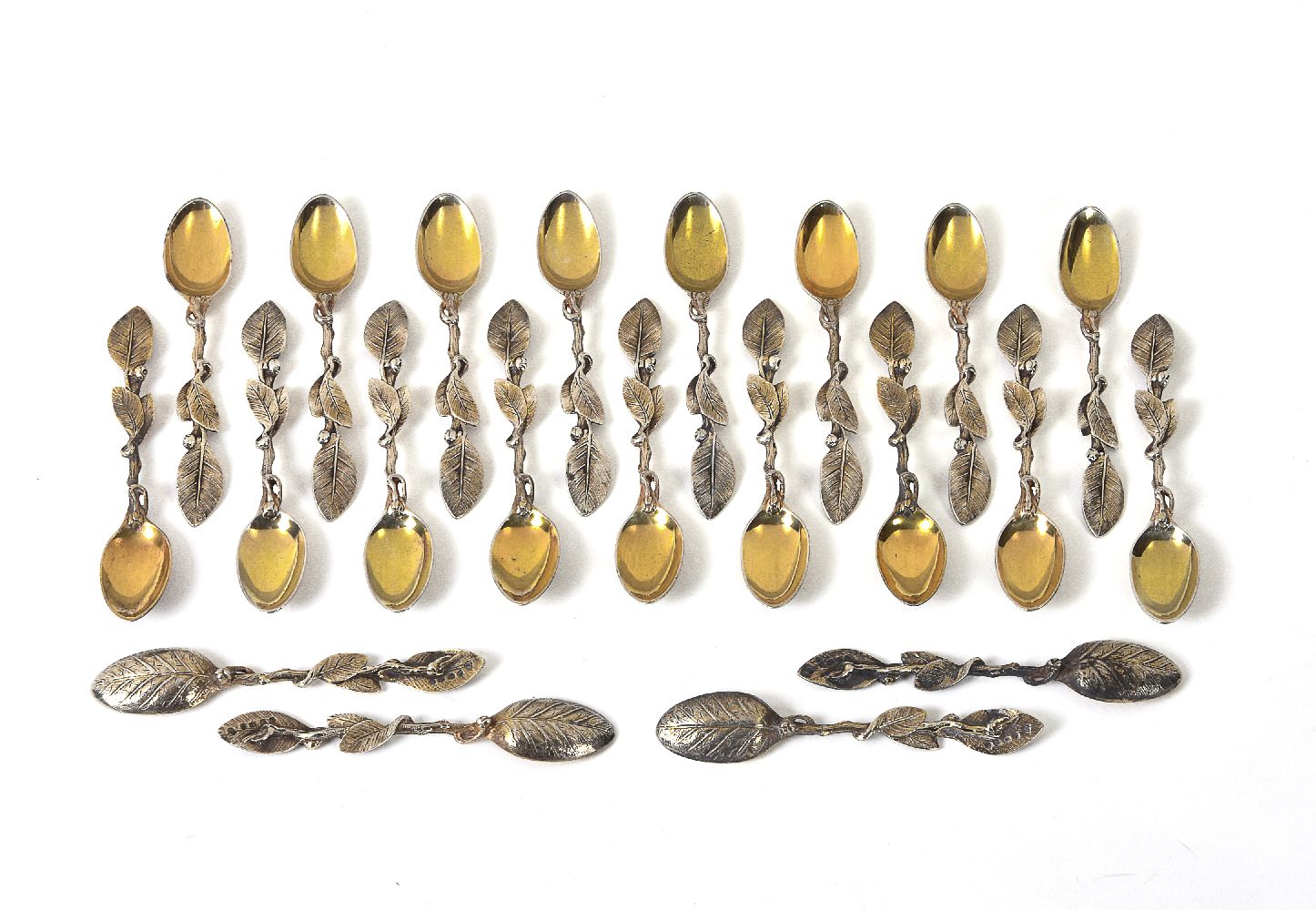 Twenty-one Victorian silver gilt cast tea spoons by Francis Higgins III