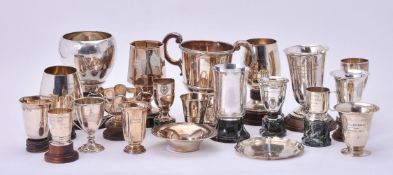 An accumulation of silver and silver coloured golfing trophy cups and similar