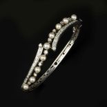 A cultured pearl and diamond bangle