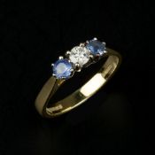 An 18 carat gold diamond and sapphire three stone ring