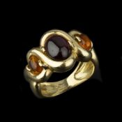 A three stone citrine and garnet three stone ring retailed by Annabel Jones