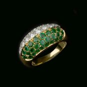 A diamond and emerald dress ring