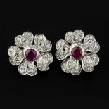 A pair of diamond and ruby flower head earrings