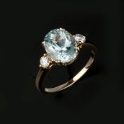 An aquamarine and diamond three stone ring
