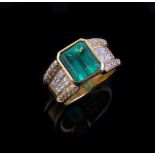 An emerald and diamond ring