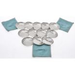 A set of twelve American silver coloured plain round dishes by Tiffany & Co.