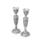 A pair of Persian silver circular candlesticks