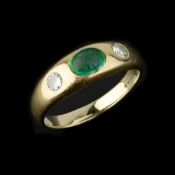 A three stone diamond and emerald ring