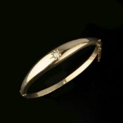 An Edwardian 18 carat gold diamond hinged bangle