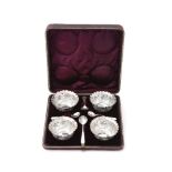 A set of four Victorian open salts with flower border and fluted rims