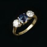 A sapphire and diamond three stone ring