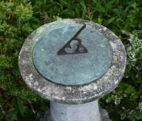 A stone composition and bronze alloy mounted garden sundial
