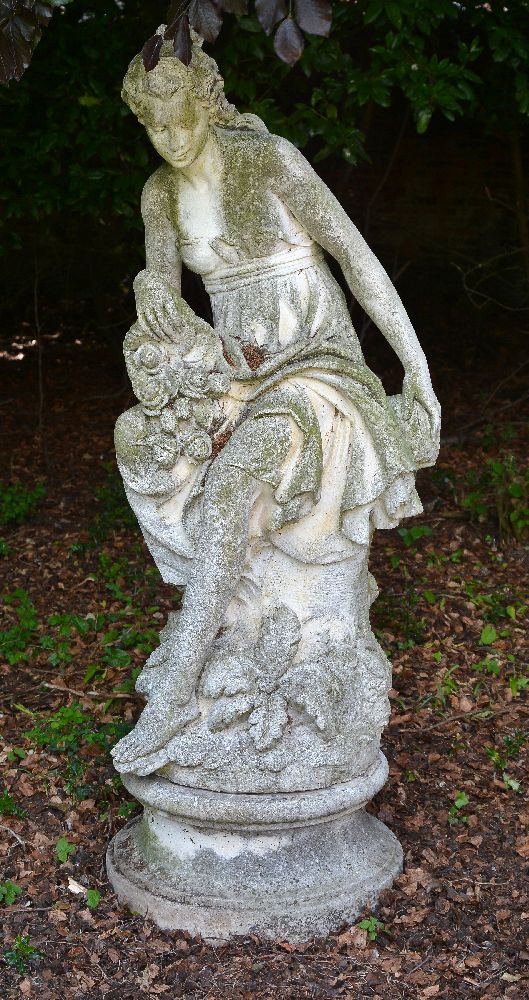 A stone composition garden model of a maiden probably emblematic of Summer,