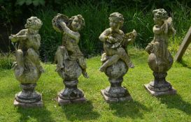 A set of four stone composition garden models of musical putti